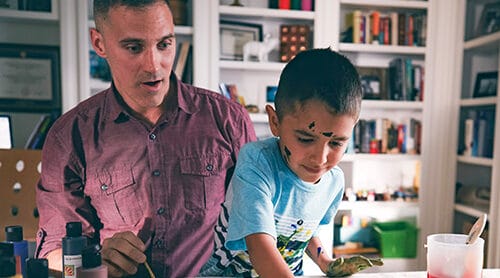 Father and son working on an art project