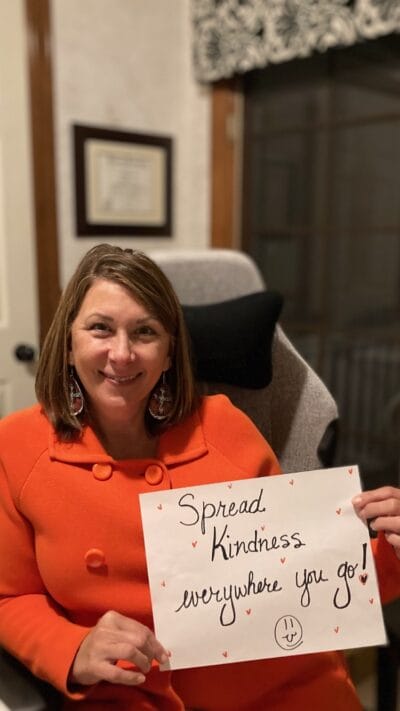 teacher with announcement in the paper