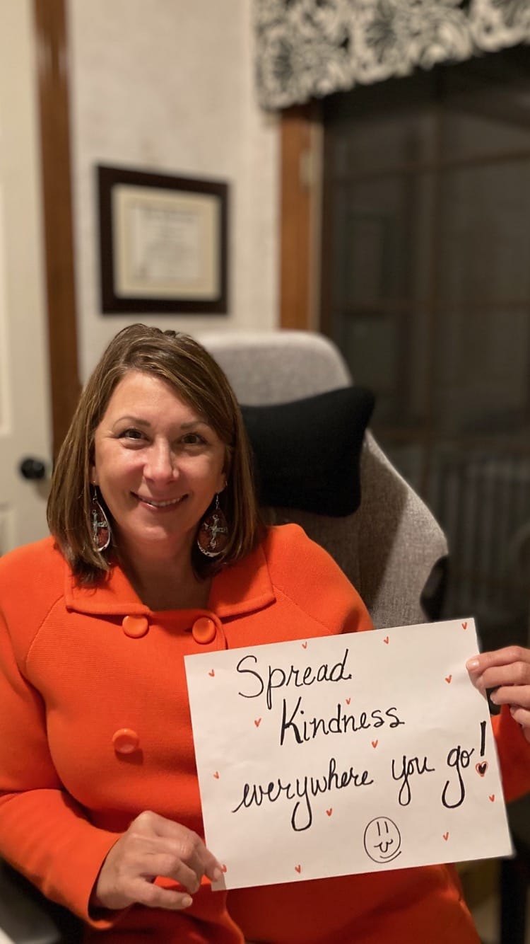 teacher with announcement in the paper