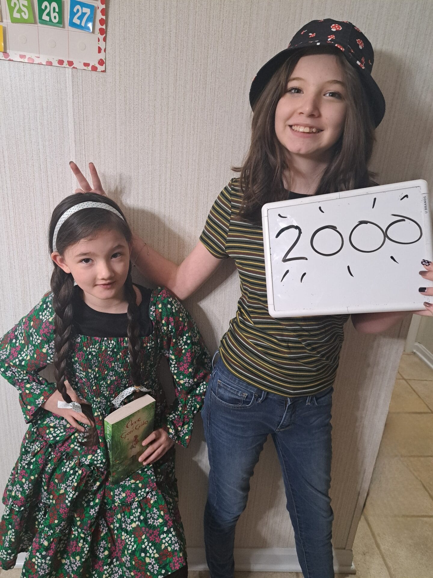girls smiling with 2000 announcement