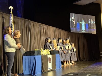 teachers with students in the graduation