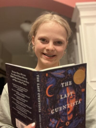 girl with "the last cuentista" book