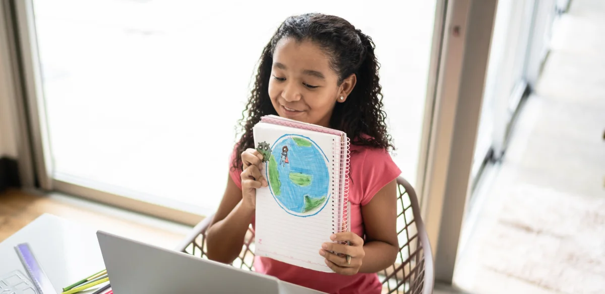 girl showing a map in her notebook