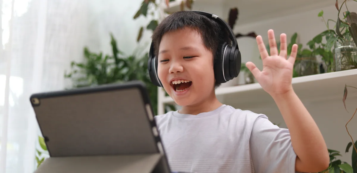 happy boy smiling in front of the computer